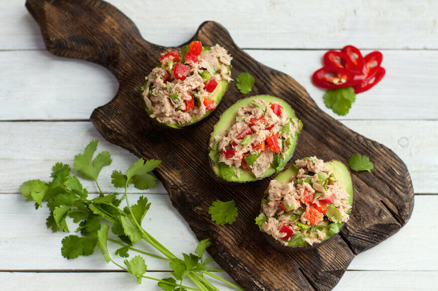 Avocados stuffed with canned tuna and vegetables.