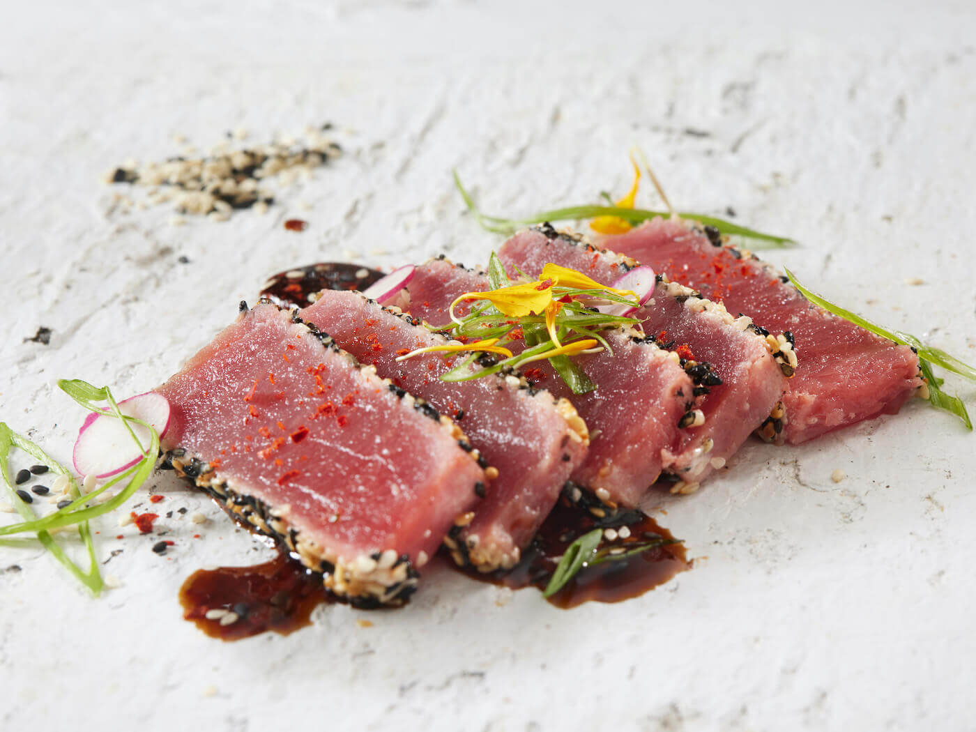 Five slices of ahi tuna tataki with a soy vinaigrette