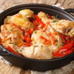 a cast iron skillet with braised chicken