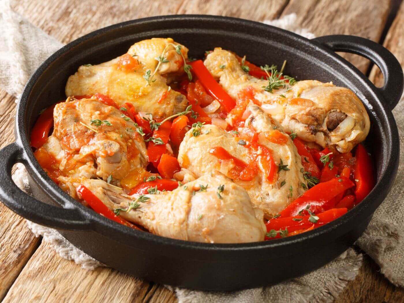 a cast iron skillet with braised chicken